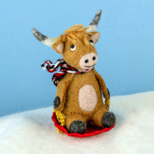 Sledding Highland Cow Ornament